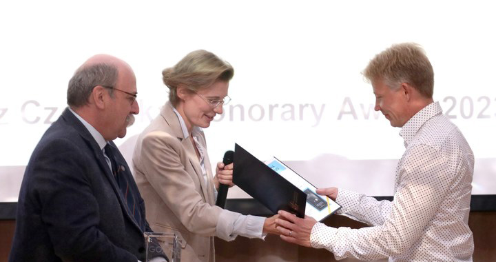 Kasia Wrzosek-Lipska and Pawel Napiorkowski handing the award to Janne Pakarinen.